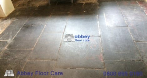 Paint, cement, lime residue, and lost grout on an old slate floor in Corris