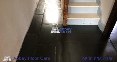 Red wax coating removed from slate near a staircase